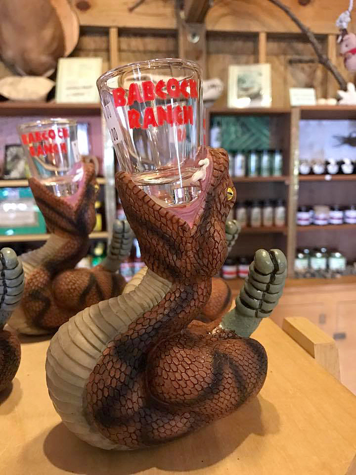 Shot glass with a holder in the shape of an alligator